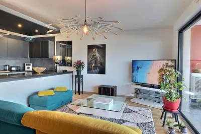 a living room with a couch and a tv at Casa Simona - View of the Gulf of Ajaccio in Ajaccio