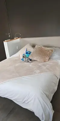 a bed with a stuffed animal on top of it at Villa 6 personnes Corse du Sud in Afa