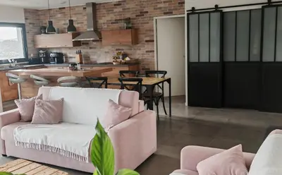 a living room with a couch and a kitchen at Villa 6 personnes Corse du Sud in Afa