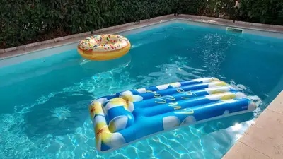 a inflatable pool with a donut in a swimming pool at Villa 6 personnes Corse du Sud in Afa