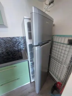 a kitchen with a stainless steel refrigerator in a room at Studio AJACCIO Sanguinaires in Ajaccio