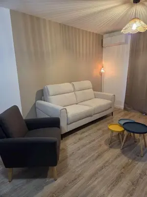 a living room with a couch and two tables at T2 proche de la mer in Venzolasca