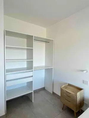 a white closet with a wooden stool in a room at Rare T2 New, Waterfront in Porticcio