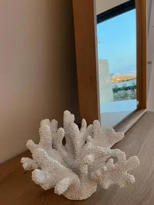 a white object sitting on a floor next to a window at Rare T2 New, Waterfront in Porticcio