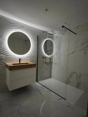 a bathroom with a sink and a mirror at Rare T2 New, Waterfront in Porticcio