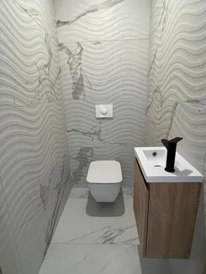 a bathroom with a toilet and a sink at Rare T2 New, Waterfront in Porticcio