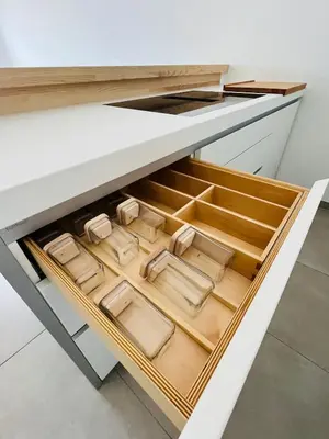 an open drawer in a kitchen with wooden drawers at Rare T2 New, Waterfront in Porticcio
