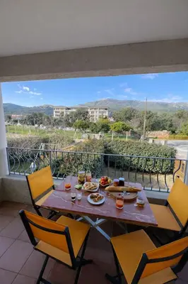 a table and chairs on a balcony with a view at Appart cosy - Lumineux avec terrasse in Borgo