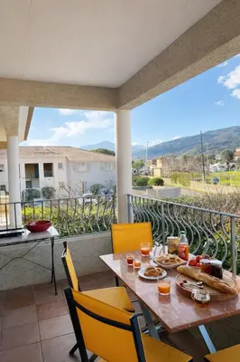 a table and chairs on a balcony with a view at Appart cosy - Lumineux avec terrasse in Borgo