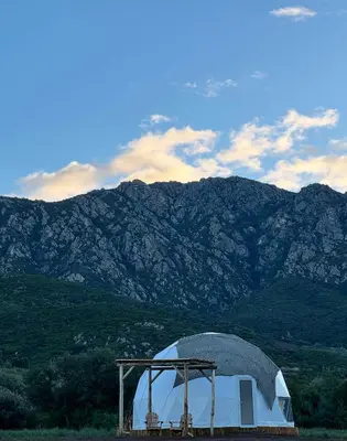 a dome tent with mountains in the background at Les Dômes du Moulin in Urtaca