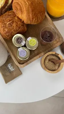 a tray of bread and croissants on a table at Les Dômes du Moulin in Urtaca