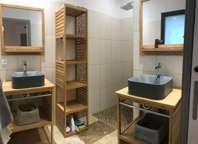 a bathroom with two sinks and two mirrors at Villa proche de St Florent Corse in Oletta