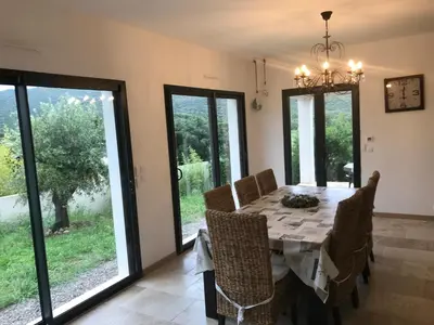 a dining room with a table and chairs at Villa proche de St Florent Corse in Oletta