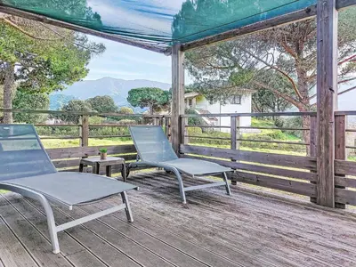 a screened in porch with chairs and a table at Holiday Home Chalet Terra Tramandera by Interhome in Calcatoggio