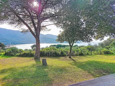 a park with trees and a view of a lake at Holiday Home Chalet Terra Tramandera by Interhome in Calcatoggio