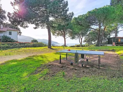 a ping pong table in the middle of a yard at Holiday Home Chalet Terra Tramandera by Interhome in Calcatoggio