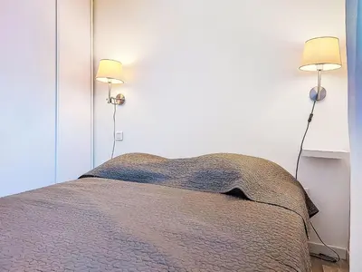 a bedroom with a bed and two lamps on the wall at Holiday Home Chalet Terra Tramandera by Interhome in Calcatoggio