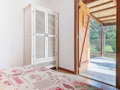 a bedroom with a bed and an open door at Holiday Home Maisonnette Terra Tramandera by Interhome in Calcatoggio