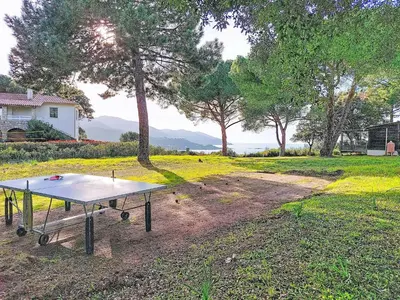 a ping pong table in the middle of a yard at Holiday Home Maisonnette Terra Tramandera by Interhome in Calcatoggio