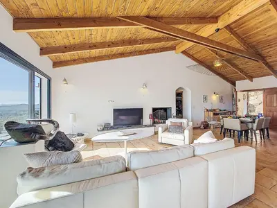 a living room with a white couch and a tv at Villa La Dorianzza by Interhome in Porto-Vecchio