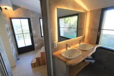 a bathroom with two sinks and a large mirror at Casa Una Storia in Sartène