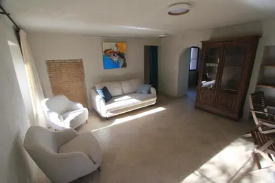 a living room with two chairs and a couch at Casa Una Storia in Sartène