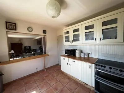 a kitchen with white cabinets and a stove top oven at Holiday Home Haus in der Nähe von Meer und Bergen- atemberaubende Aussicht- by Interhome in Calcatoggio