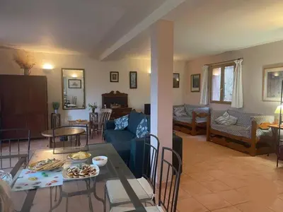 a living room with a couch and a table at Holiday Home Haus in der Nähe von Meer und Bergen- atemberaubende Aussicht- by Interhome in Calcatoggio