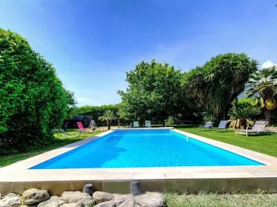 a swimming pool in a yard with trees at Holiday Home Exklusivität Korsika- Steinhaus mit Charme by Interhome in Santa-Lucia-di-Moriani