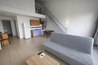 a large living room with a couch and a table at Appartement Duplex 6 personnes - Soléa 204 - Vue Mer in Serra-di-Ferro