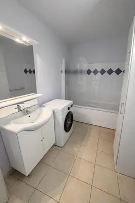 a bathroom with a sink and a washing machine at Appartement Duplex 6 personnes - Soléa 204 - Vue Mer in Serra-di-Ferro