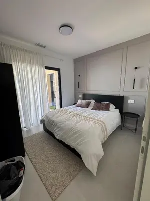 a bedroom with a large bed and a large window at Magnifique villa 4 chambres saint lucie de porto Vecchio in Zonza