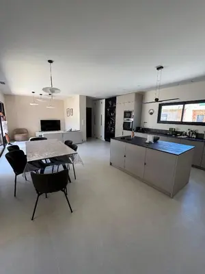 a large kitchen and dining room with a table and chairs at Magnifique villa 4 chambres saint lucie de porto Vecchio in Zonza