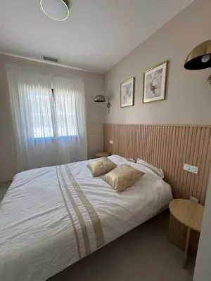 a bedroom with a bed with two pillows on it at Magnifique villa 4 chambres saint lucie de porto Vecchio in Zonza