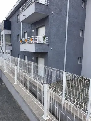 a white fence next to a building at Studio récent Corte in Corte