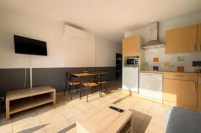 a kitchen with a table and a dining room at Appartement 4 personnes - Soléa 126 - Vue Nature in Serra-di-Ferro
