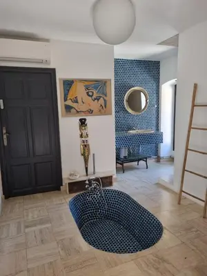 a room with a black door and a rug on the floor at Ferme Canioni in Belgodère