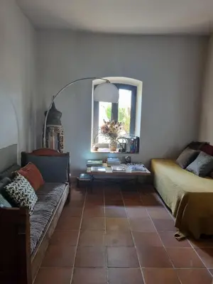 a living room with a couch and a window at Ferme Canioni in Belgodère