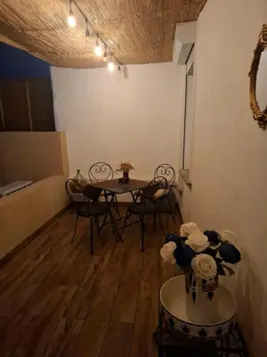 a dining room with a table and chairs in a room at Appartement terrasse au cœur d'Ajaccio in Ajaccio