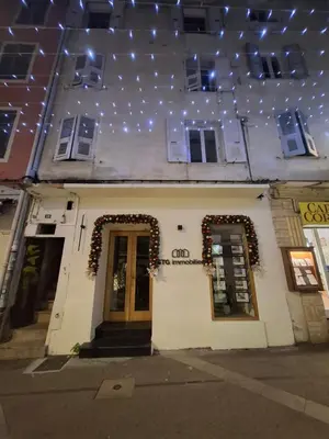 a white building with christmas lights on the ceiling at Appartement terrasse au cœur d'Ajaccio in Ajaccio