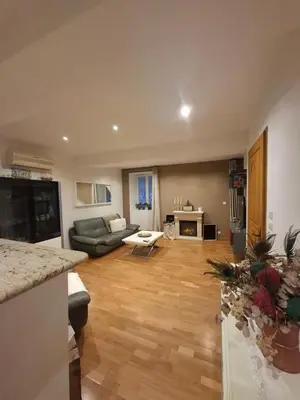 a living room with a couch and a table at Appartement terrasse au cœur d'Ajaccio in Ajaccio