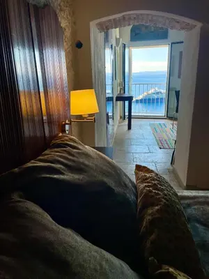 a bedroom with a bed with a view of the ocean at Fleur de Falaise in Bonifacio