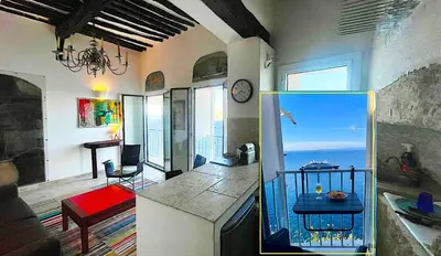 a living room with a fish tank in a kitchen at Fleur de Falaise in Bonifacio