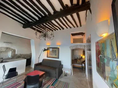 a living room with a couch and a table at Fleur de Falaise in Bonifacio