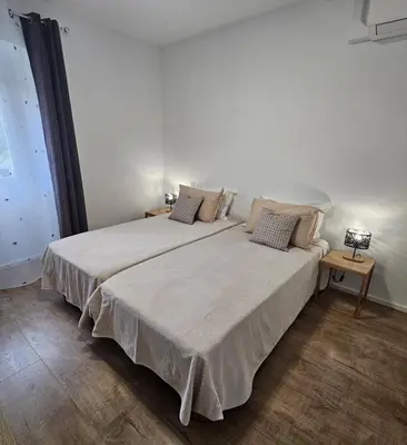 a bedroom with a large white bed with pillows at Séjournez entre mer et montagne en Corse-du- Sud in Cauro
