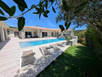 a backyard with a swimming pool and a house at Villa Luxueuse avec piscine privee chauffee in Porto-Vecchio