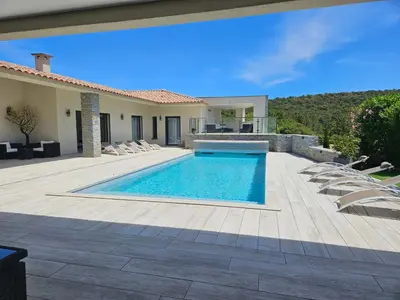 a villa with a swimming pool and a patio at Villa Luxueuse avec piscine privee chauffee in Porto-Vecchio
