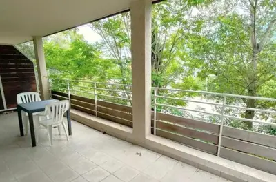 a balcony with a table and chairs and a view of trees at Grand F2 avec terrasse spacieuse, Centre Corte in Corte