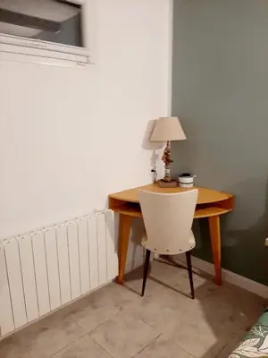 a desk with a chair and a lamp on it at Estancia el Sauce in Taglio-Isolaccio
