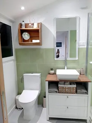 a bathroom with a white toilet and a sink at Estancia el Sauce in Taglio-Isolaccio